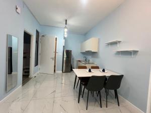 a kitchen and dining room with a table and chairs at Cubic Botanical KL Bangsar Entire Unit Parking/Pool in Kuala Lumpur