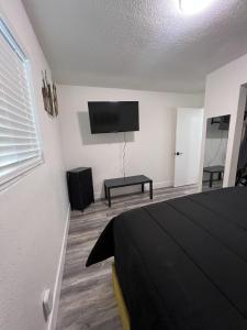 a bedroom with a bed and a flat screen tv at Cozy and Spacious Home in Las Vegas