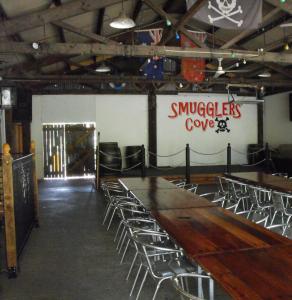 a room with chairs and a long wooden table at Smugglers Cove Holiday Village in Forster +82 photos