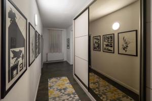 a hallway with framed pictures on the walls at Casa Ryu in Cluj-Napoca