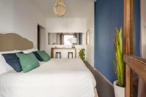 a bedroom with a white bed with blue walls at House Putignani 181 in Bari