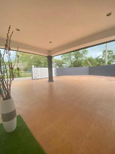 a large empty patio with a vase on the grass at IPOH LYL EVERGREEN HOMESTAY in Ipoh