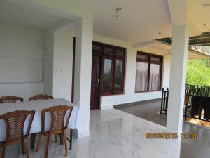 a dining room with a table and chairs at Green View Holiday Resort in Elkaduwa