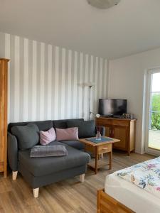 a living room with a couch and a coffee table at Ferienhaus Kaptein Meyer in Zingst