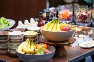 a buffet with bowls of fruit on a table at Shibuya Excel Hotel Tokyu in Tokyo