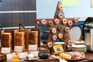 a display of donuts and pastries on a table at Shibuya Excel Hotel Tokyu in Tokyo