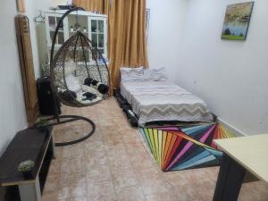 a room with a hammock and a bed and a mirror at Sahal-House in Djibouti