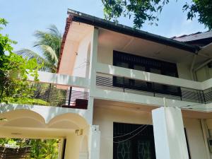 a house with a balcony in front of it at Nallur Residence in Jaffna