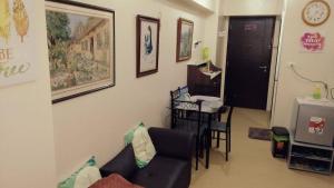 a living room with a couch and a table at Avida Atria Tower 1 Studio Type Condominium in Iloilo City