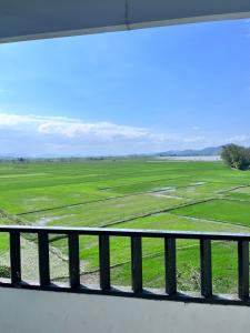 a view of a green field from a window at Lak View hotel in Lien Son