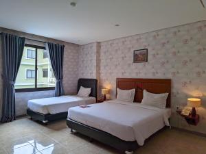 Postel nebo postele na pokoji v ubytování Hotel Nalendra Plaza Subang