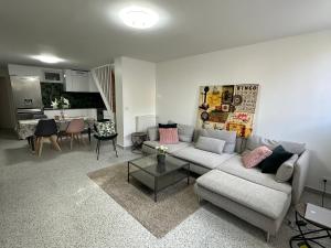 a living room with a couch and a table at Dream House Paris 5 chambres proche M7et M14 in Villejuif