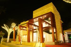 a building decorated with christmas lights at night at LGR Club House in Poringalkuthu