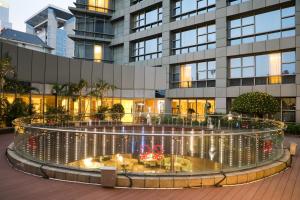 a building with a fountain in front of it at Nanning Marriott Hotel in Nanning