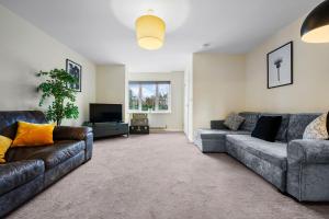 a living room with two couches and a tv at 4BR Contractor House in Birmingham w/Parking in West Bromwich