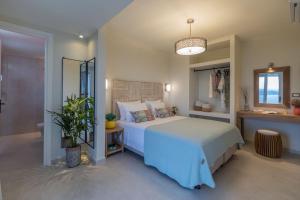 a bedroom with a bed and a potted plant at THALASSA VIEW RESIDENCE in Argostoli