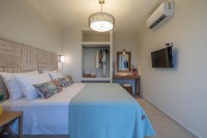 a bedroom with a large bed and a tv at THALASSA VIEW RESIDENCE in Argostoli