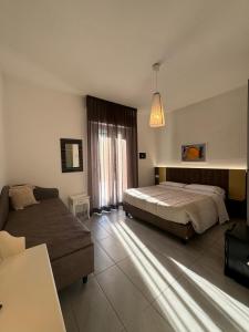 a large bedroom with a bed and a couch at Villa Liliana in Cervia