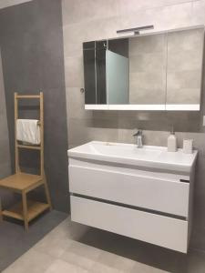 a bathroom with a white sink and a mirror at New and spacious accommodation in Ioannina! in Ioannina