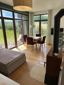 a bedroom with a bed and a table and chairs at DELTA Apartament "Osada Śnieżka" koło Karpacza in Łomnica