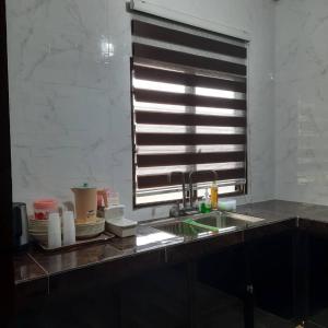 a kitchen with a sink and a window at Hidden Homestay in Marang