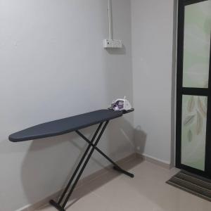 a black table in a room next to a wall at Hidden Homestay in Marang