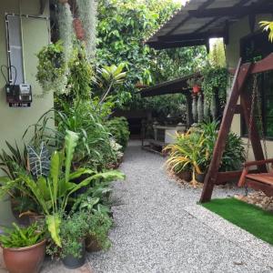 a garden with a bunch of plants and a bench at Hidden Homestay in Marang