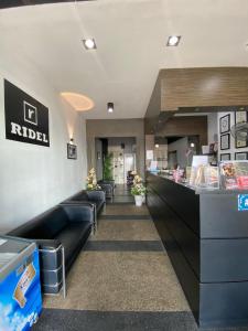 a waiting room at a riel restaurant with couches at Ridel Sunset Hotel in Kota Bharu