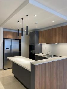 a kitchen with a counter top and a refrigerator at Elegance and Comfort in Christiansborg