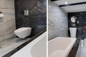 ein Badezimmer mit einem WC und einer Badewanne in der Unterkunft OYO Tudor Oaks Lodge Stevenage North in Astwick