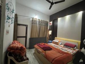 a bedroom with a bed and a ceiling fan at Occasions in Jammu