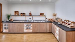 a kitchen with a large counter with a sink at Landhotel Zur Eiche in Buxtehude
