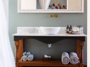 a shelf with a bowl on top of a sink at Lodge Damaraland in Khorixas