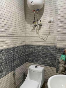 a bathroom with a toilet and a sink at Aquila Home 2 BHK South Delhi Near Ashram Metro in New Delhi