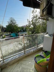 a balcony with a view of a view of a yard at Aquila Home 2 BHK South Delhi Near Ashram Metro in New Delhi