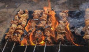 a bunch of different types of food on a grill at Hotel Day In Emporium in Lahore