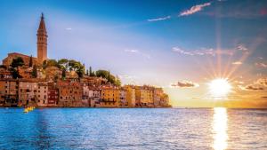 a view of a city from the water at sunset at Casa di Luna Rovigno in Rovinj