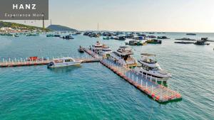 a group of boats docked at a dock in the water at HANZ LAGOON SUNSET ITALIANO BOUTIQUE in Phu Quoc