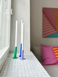 three electric toothbrushes in a corner of a room at Cute loft by Tram Stop in Helsinki