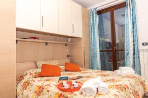 Posteľ alebo postele v izbe v ubytovaní Residenza Coccinelle vista Lago d'Iseo