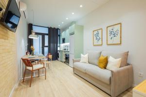 a living room with a couch and a table at FLORIT FLATS - The Sorolla Apartments in Valencia