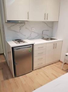 a kitchen with a sink and a dishwasher at Sea view Aristotelous square in Thessaloniki