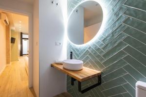 W łazience znajduje się umywalka i lustro. w obiekcie FLORIT FLATS - The Sorolla Apartments w Walencji