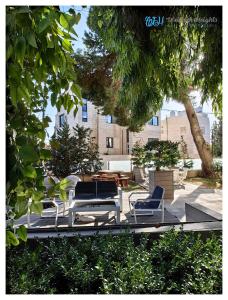 a group of chairs and a table in a courtyard at Weibdeh Heights Hotel Suites in Amman