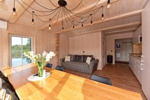 a living room with a table and a couch at Namelis ant vandens "Giliaus namelis" in Tytuvėnai +70 photos
