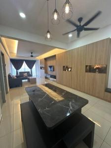 uma sala de estar com uma mesa e uma ventoinha de tecto em Ulike~Homestay~C~3Room-The Venus em Sitiawan