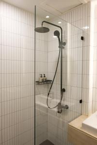 a shower with a glass door in a bathroom at Upscale 3-bedroom 3-bathroom suite 1 min to BTS Prompong in Bangkok