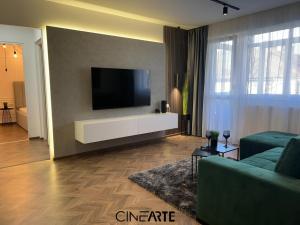a living room with a flat screen tv on a wall at CineArte Residence in Caransebeş +16 photos