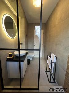 a bathroom with a sink and a mirror at CineArte Residence in Caransebeş