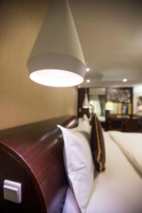 a bedroom with a bed with a light above it at Anabel Apartment and Suites, Abuja in Abuja